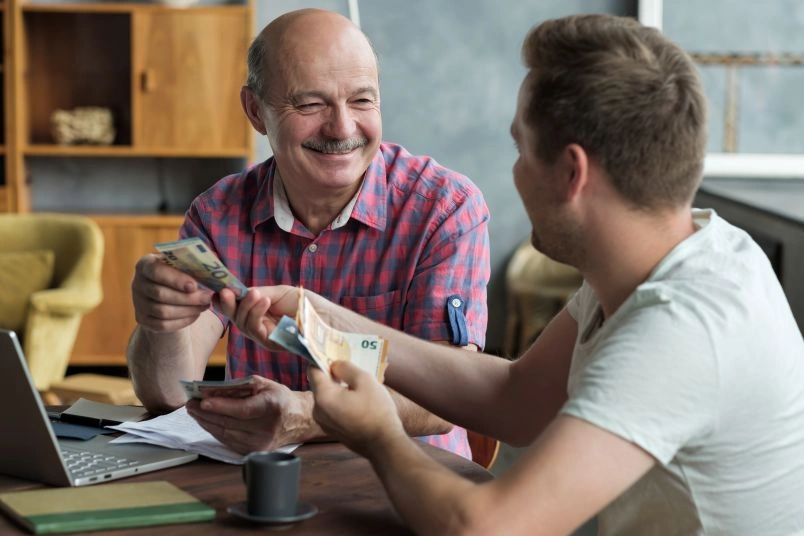 Senior man receiving cash assistance at office